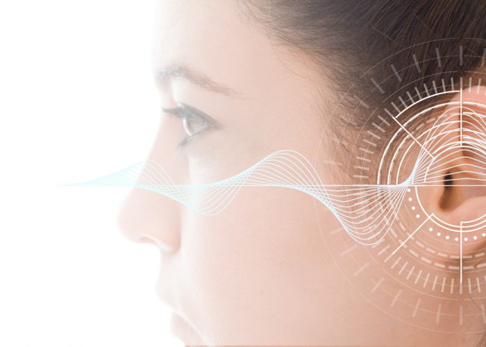 Hearing test showing ear of young woman with sound waves simulation technology #image_title